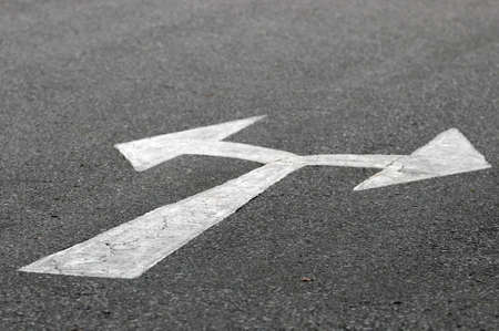 arrow sign on surface of street