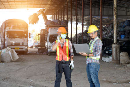 Portrait worker on recycle center,sanitation worker working in recycling plant Staff wearing reflective vests in an industrial interiorの写真素材