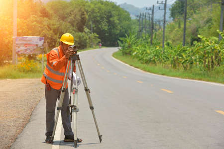 Surveyor engineer worker making measuring with theodolite on road works.survey engineer in construction site.の写真素材