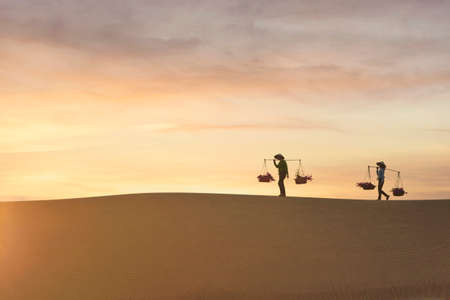 Asian woman Vietnam culture traditional dress on sandune during sunset ,traditional costume ,Muine Vietnamの写真素材