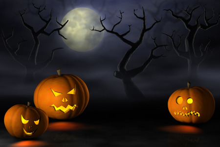 Frightening Halloween pumpkins or Jack O'Lanterns in a spooky and misty forest under a full moon at night.の写真素材
