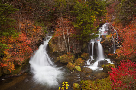 The Ryuzu Falls Ryuzu-no-taki,  near Nikko, Japan surrounded by autumn colours.の写真素材