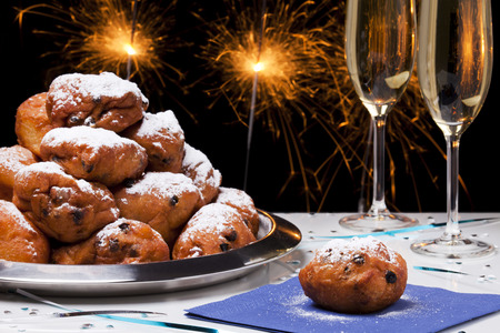 'Oliebollen', traditional Dutch pastry for New Year's Eve and two glasses of champagne.の写真素材