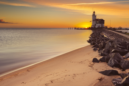 The lighthouse on the island of Marken in The Netherlands. Photographed at sunrise.の写真素材