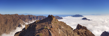The mountains peaks around Roque de los Muchachos on La Palma, Canary Islands, Spain above the clouds.の写真素材