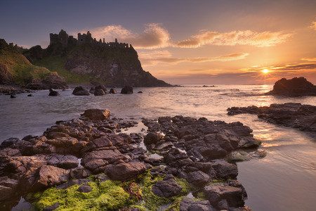The ruins of the Dunluce Castle on the Causeway Coast of Northern Ireland. Photographed at sunset.の写真素材
