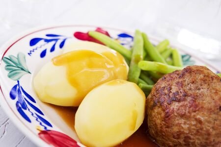 A plate with potatoes, meat and vegetables; a typical Dutch meal at dinnertime.の写真素材