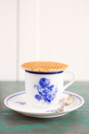 Cup of coffee with a Dutch stroopwafel cookie or caramel waffle.の写真素材