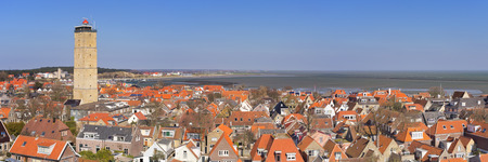 West-Terschelling village with the Brandaris lighthouse on the island of Terschelling in The Netherlands on a bright and sunny day.の写真素材