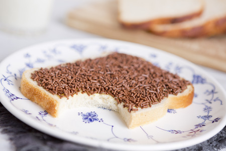 A sandwich with chocolate sprinkles or a 'boterham met hagelslag', Dutch traditional food.の写真素材