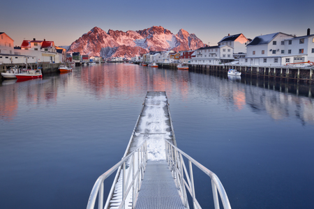 The harbor of Henningsvær on the Lofoten in northern Norway, photographed at sunrise.の写真素材