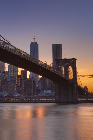 Brooklyn Bridge with the New York City skyline in the background, photographed at sunset.の写真素材