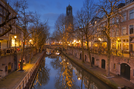 The Oudegracht canal and Dom church in Utrecht in The Netherlands at night.の写真素材