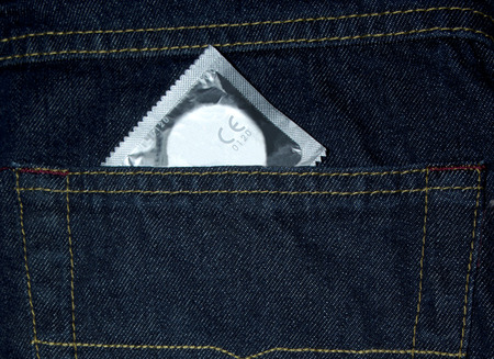 Condom in the pocket of a blue jeansの写真素材
