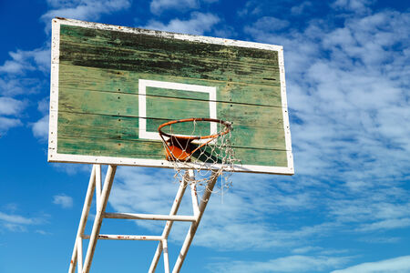 Basketball hoop is old wood.