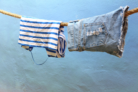 Wet clothes hanging on ropeの写真素材