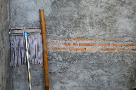 Vintage concrete wall and mop cleaning equipmentの写真素材