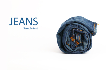 Roll of blue jeans on a white backgroundの写真素材