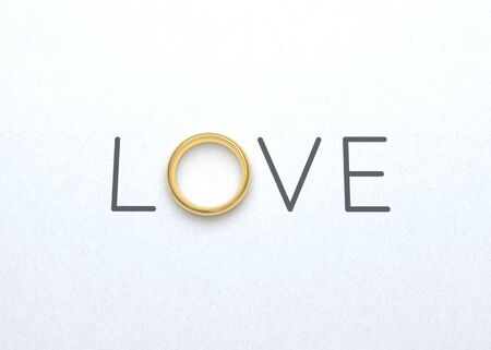 The word love with wedding ring on white paper for valentines day background. 3D illustrationの写真素材