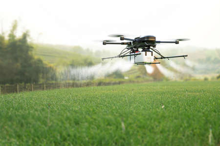 Drone spraying pesticide on wheat field. 3D illustrationの写真素材