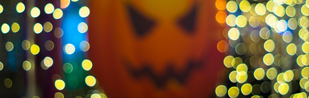 motion blurry halloween pumkin and bokeh beatiful yellow lightの写真素材