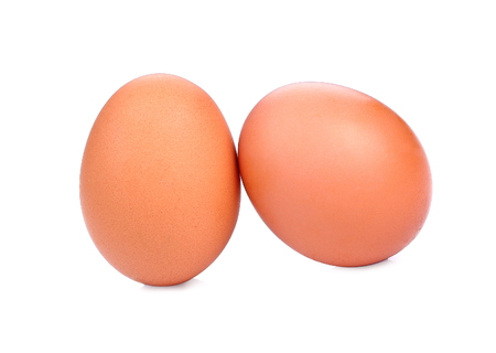 two brown eggs isolated on white background.の写真素材