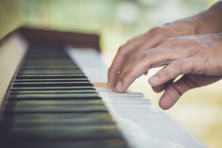Close up man hand musician playing piano.の写真素材