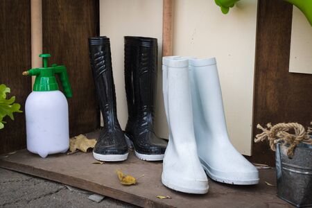 Gardening tools white boots and black boots.の写真素材