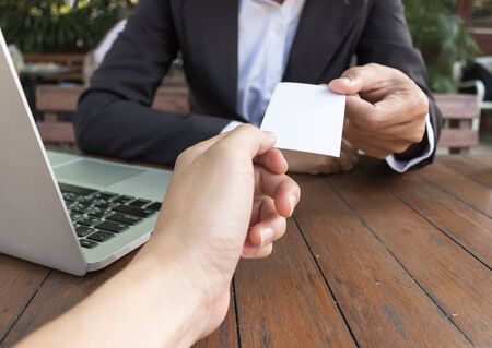 Business woman give business card for customer in coffee shop.の写真素材