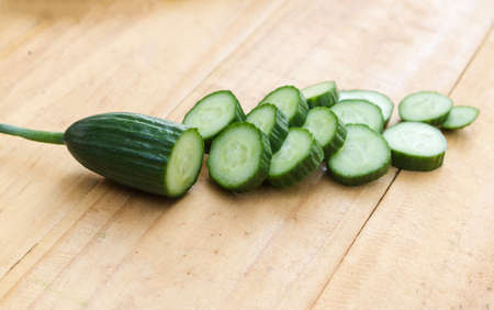 Close up cucumber slice on wood table  background.の写真素材