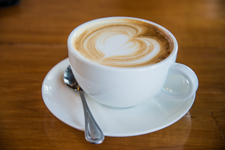 Latte cup white Background wood taken from an oblique angle.の写真素材