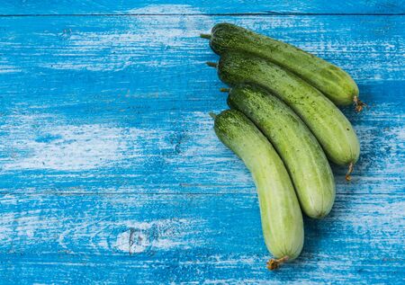 Cucumber natural skin Put four balls on the wooden floor in blue and white. Focus cucumber.の写真素材