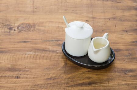 Syrup for coffee with a white cup placed on a wooden floor.
