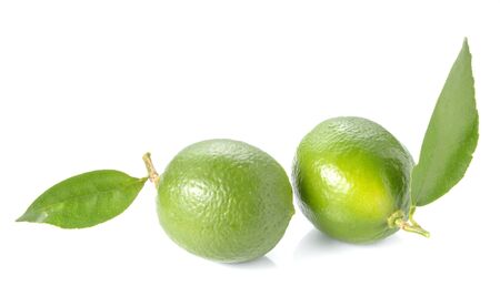 Two green lemon,leaves placed on wooden floor.の写真素材