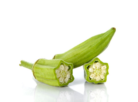 Okra cut pieces placed on white background.の写真素材