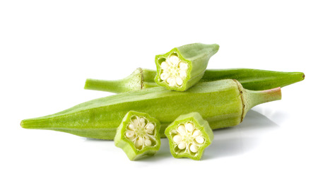 Okra cut pieces placed on white background.の写真素材