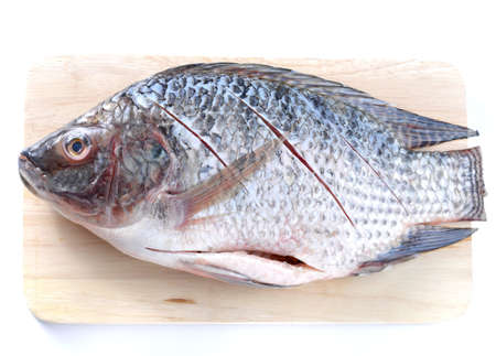Cooking fish on Wooden cutting boards,placed on white background.の写真素材