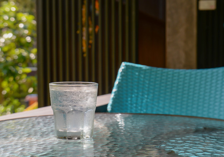 Glass water placed on Glass table.focus glass water.の写真素材