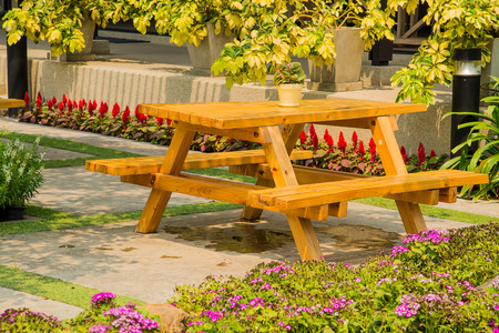 Wooden Table with chairs in garden.