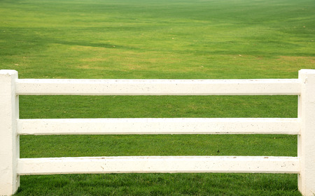 Cement white fence , White fence , grass background.の写真素材