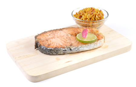 Salmon steaks,Turmeric rice in glass bowl,wooden Cutting Board on white background.の写真素材