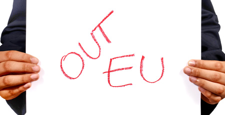 Hand man holding signs out EU,Out EU signs with red writing on white paper.Write by hand.の写真素材