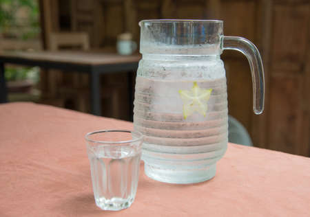 Glass jars filled with water on table.の写真素材