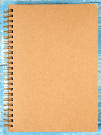 Brown notebook on blue wooden floor.の写真素材