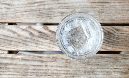 glass water on wooden table.Top view focus.の写真素材