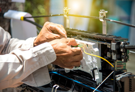 Technicians are install cabinet on fiber optic cable.の写真素材