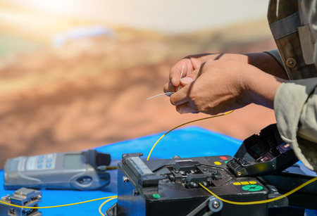 Technicians are cutting and fusion fiber optic cables.の写真素材