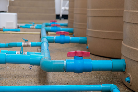 Blue water pipe installation from pump to tank.の写真素材