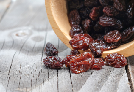 Dried grapes on wooden floor.の写真素材