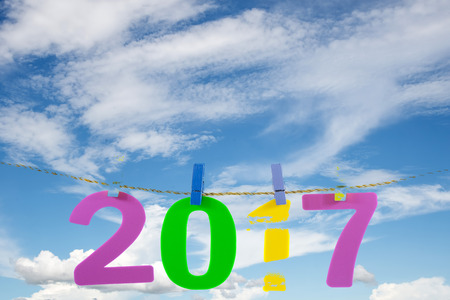 New Year 2017 number on blue sky and white cloud background.